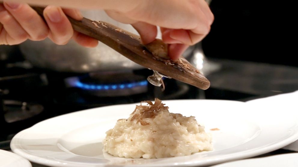  White truffles being shaved onto an Italian dish at Urbani Tartufi, the world's largest truffle company, in Sant'Anatolia di Narco, in the province of Perugia, Italy. 
