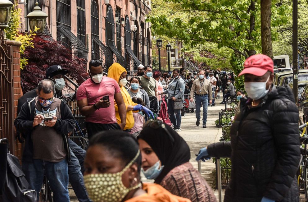 PHOTO: People wait on a long line to receive a food bank donation at the Barclays Center, May 15, 2020, in the Brooklyn borough in New York City.