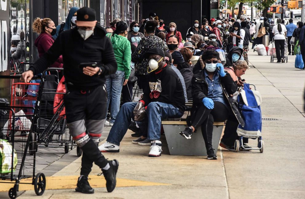 PHOTO: People wait on a long line to receive a food bank donation at the Barclays Center, May 15, 2020, in the Brooklyn borough in New York City.