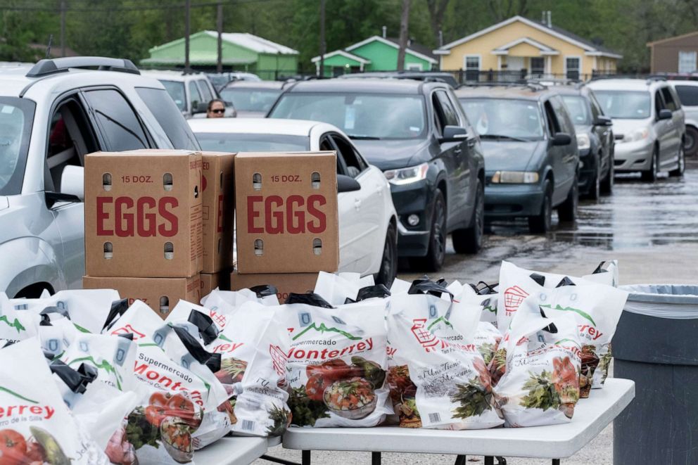 PHOTO: Free food is provided to families by the Houston Independent School District, along with the Houston Food Bank, at area high schools during the outbreak of Covid-19, March 16, 2020.