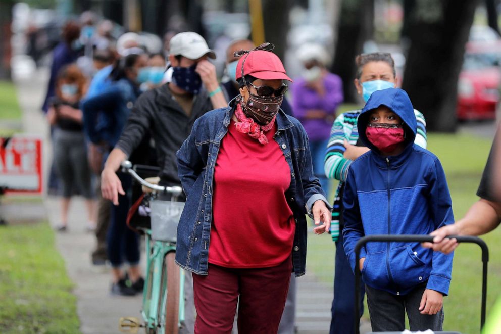 PHOTO: People line up for food at a food distribution point for people economically impacted by the coronavirus pandemic, organized by New Orleans City Councilman Jay Banks, in New Orleans, April 29, 2020. 