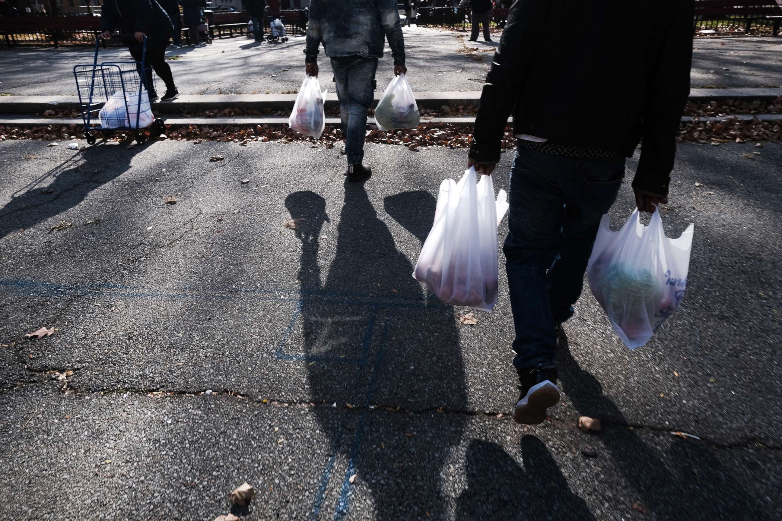 PHOTO: People receive a free Thanksgiving turkey and other holiday food staples outside of a housing project in Harlem, Nov. 23, 2021, in New York City.