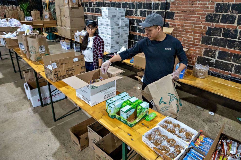 PHOTO: Volunteers at Hook Hall prepare care packages for scores of suddenly unemployed restaurant and hospitality workers in Washington, March 19, 2020.