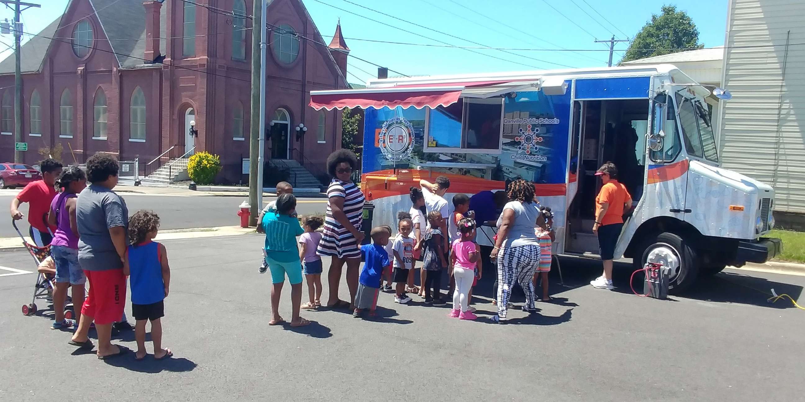 PHOTO: Students line up to a food truck providing free meals by Danville Public Schools in Virginia, June 11, 2019. 