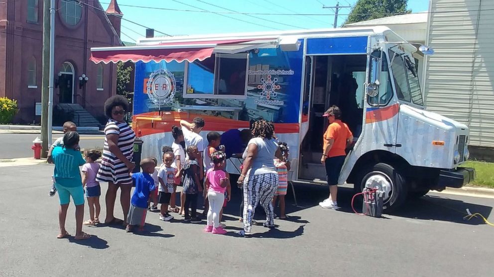 PHOTO: Students line up to a food truck providing free meals by Danville Public Schools in Virginia, June 11, 2019. 