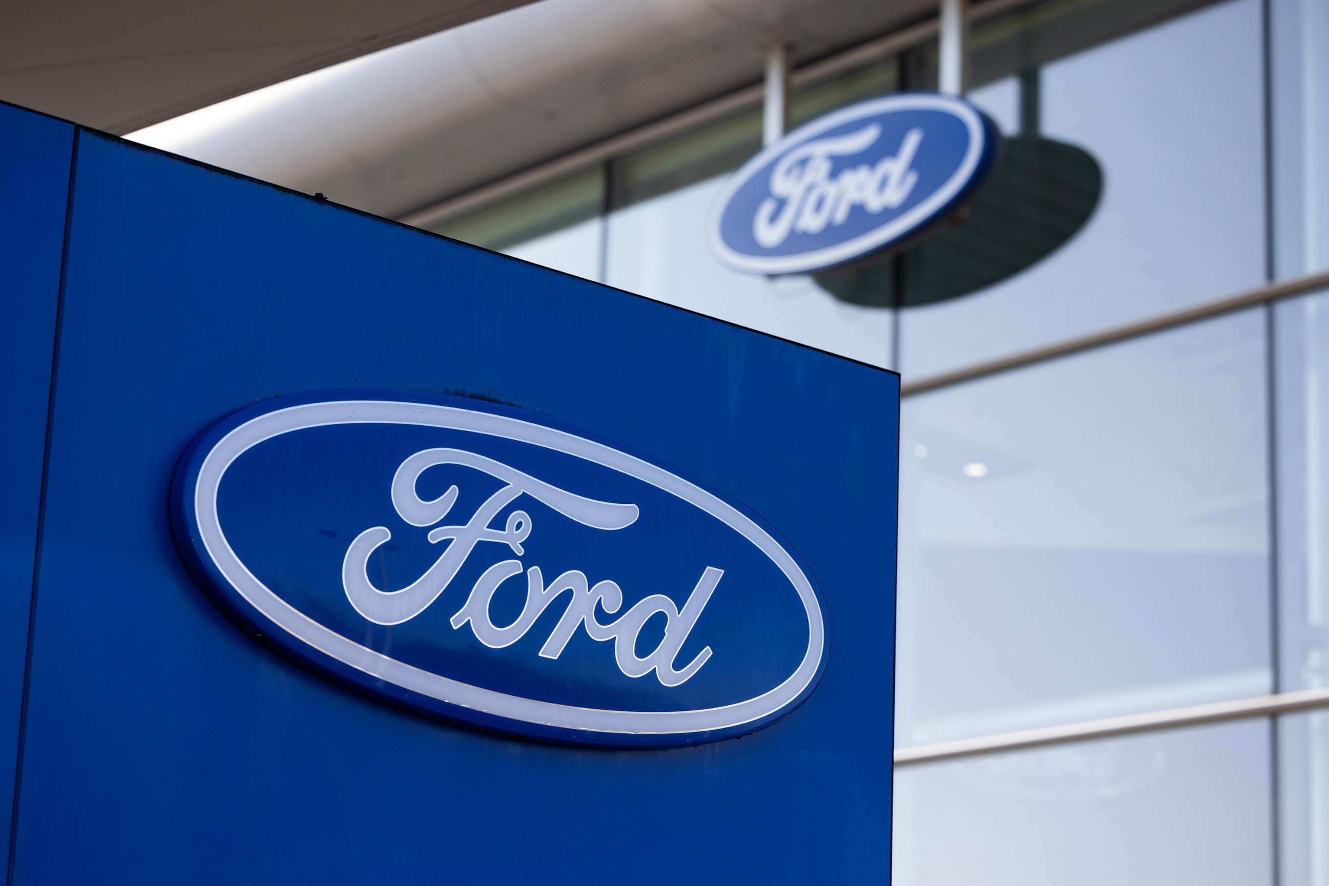 PHOTO: Logos are sen outside of a Ford Motor Co. dealership in Basildon, UK, Feb. 14, 2023.