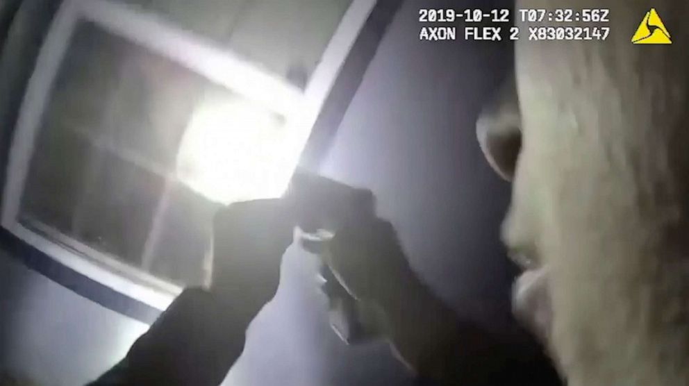 PHOTO: In this Oct. 12, 2019, image made from a body camera video released by the Fort Worth Police Department an officer shines a flashlight into a window in Fort Worth, Texas.