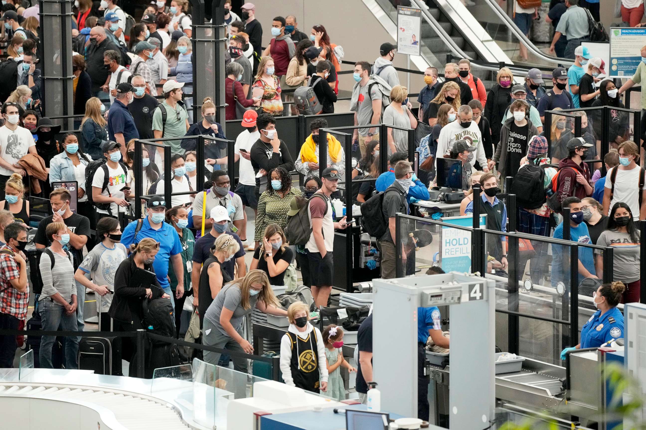 PHOTO: Travelers make their way through the north security checkpoint at Denver International Airport Friday, July 2, 2021.