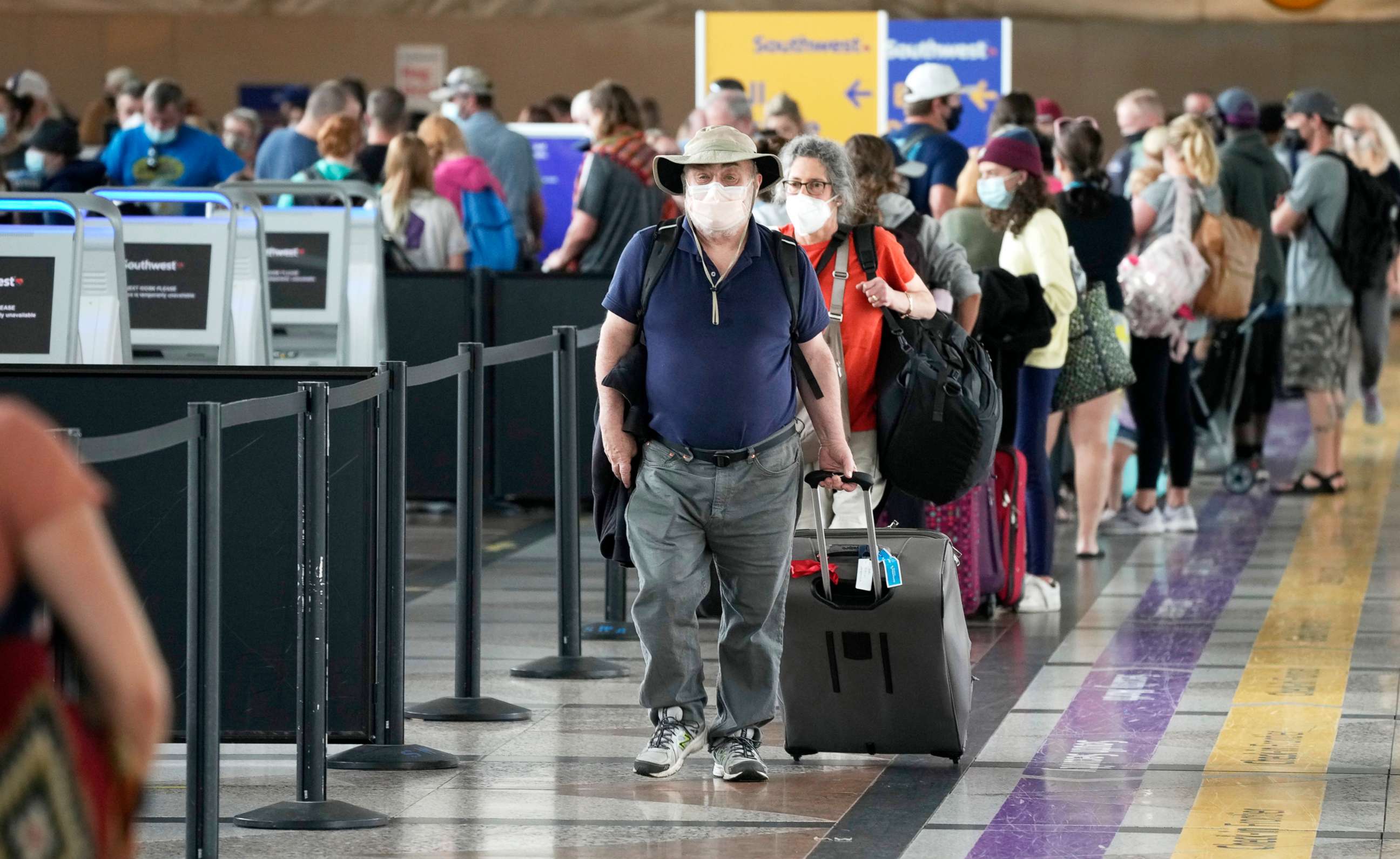 PHOTO: A line of travelers make their ways from the ticketing counter for Southwest Airlines to the nearby south security checkpoint at Denver International Airport, July 2, 2021.