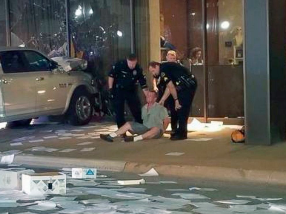 PHOTO: A man is detained after crashing his pickup truck into the side of the Fox affiliate television station building in downtown Dallas, Sept. 5, 2018. 