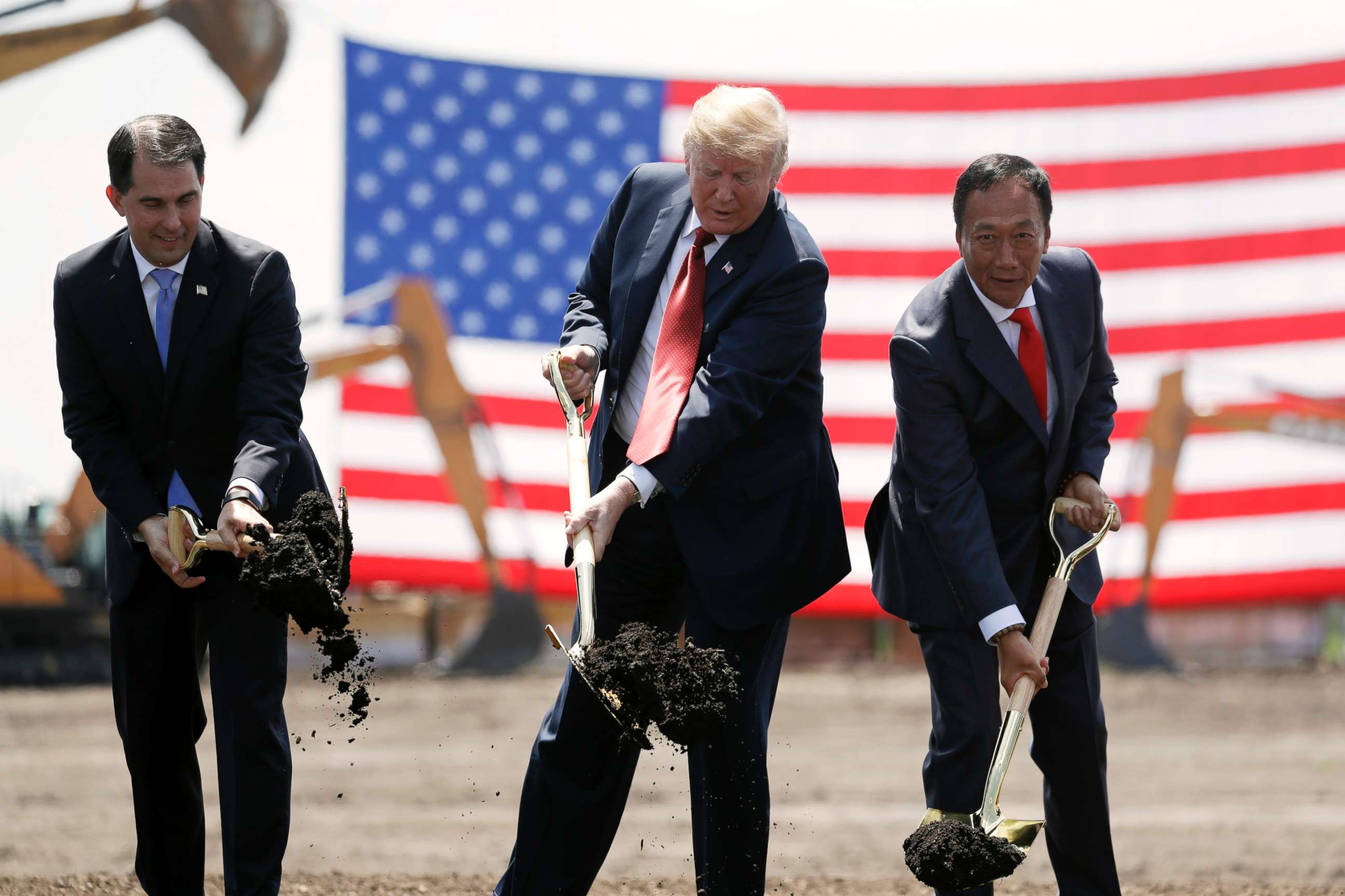 PHOTO: President Donald Trump, center, along with Wisconsin Gov. Scott Walker, left, and Foxconn Chairman Terry Gou participate in a groundbreaking event for the new Foxconn facility in Mt. Pleasant, Wis., June 28, 2018.