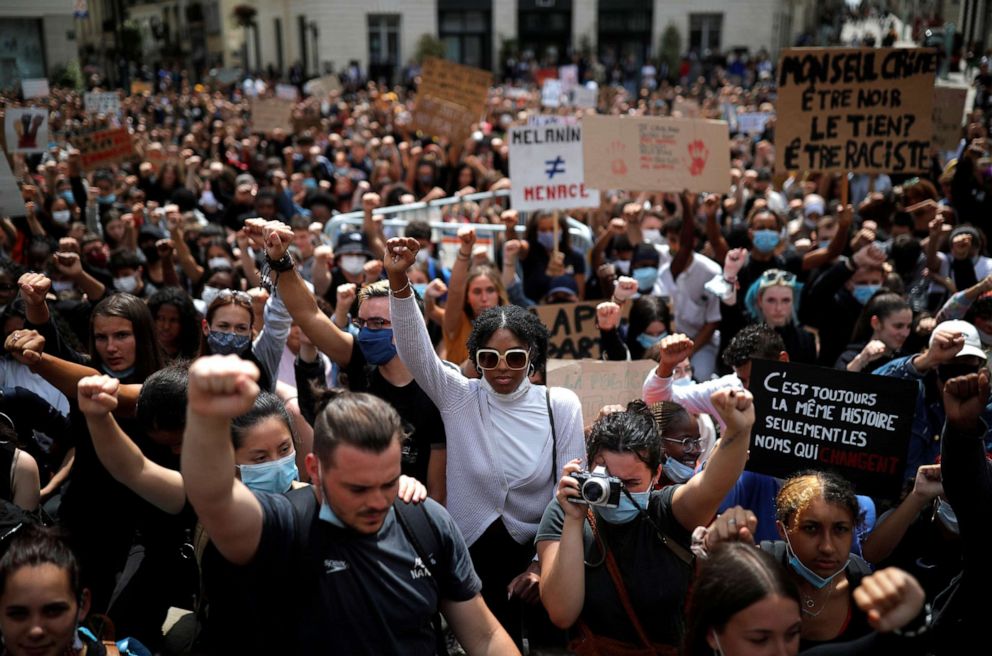 PHOTO: People raise their fists during a protest against police brutality and the death in Minneapolis police custody of George Floyd, in Nantes, France, June 8, 2020.