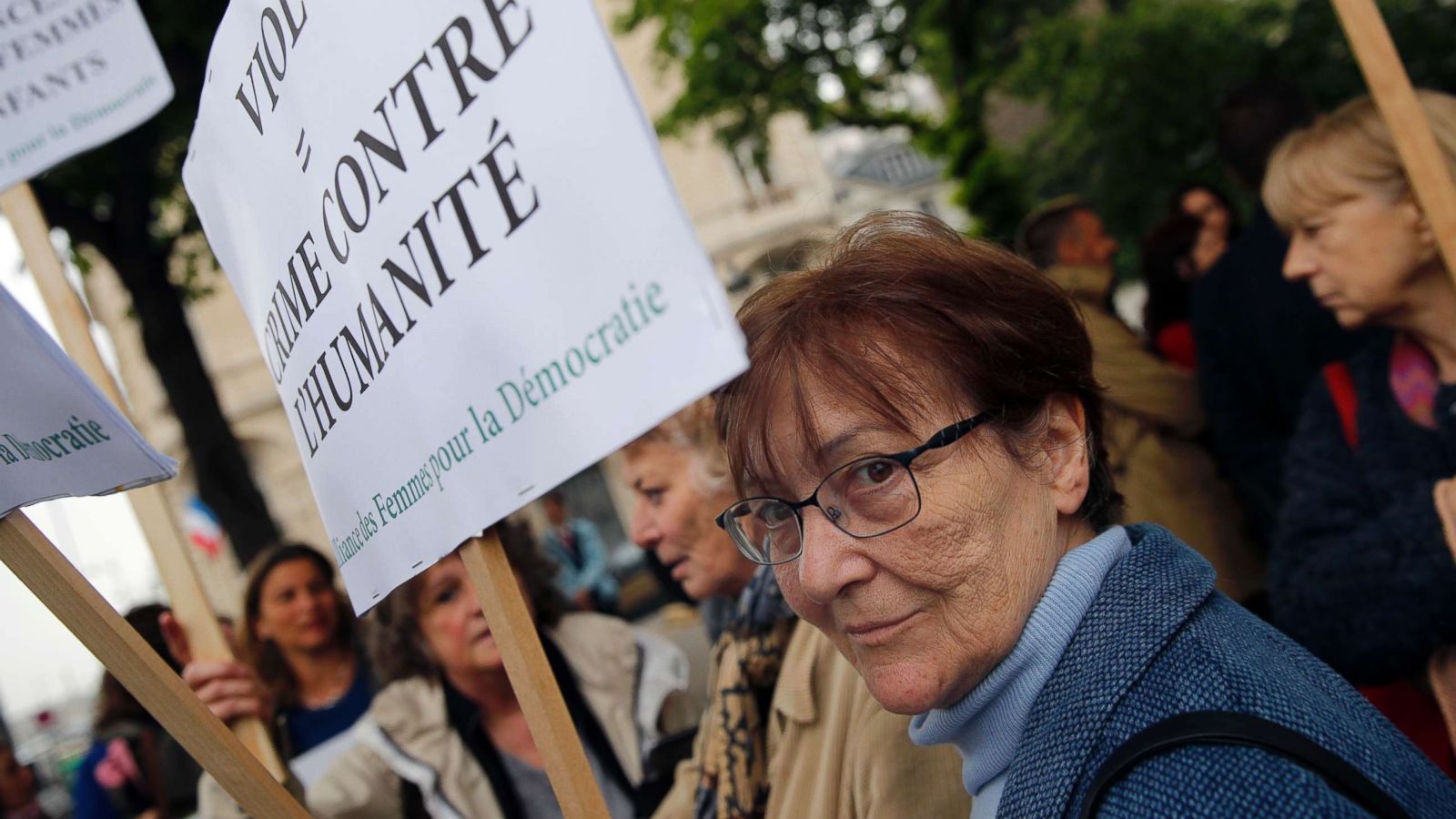 PHOTO: A woman holds a banner reading: Rape: crime against humanity, as she demonstrates in front of National Assembly in Paris, May 15, 2018.