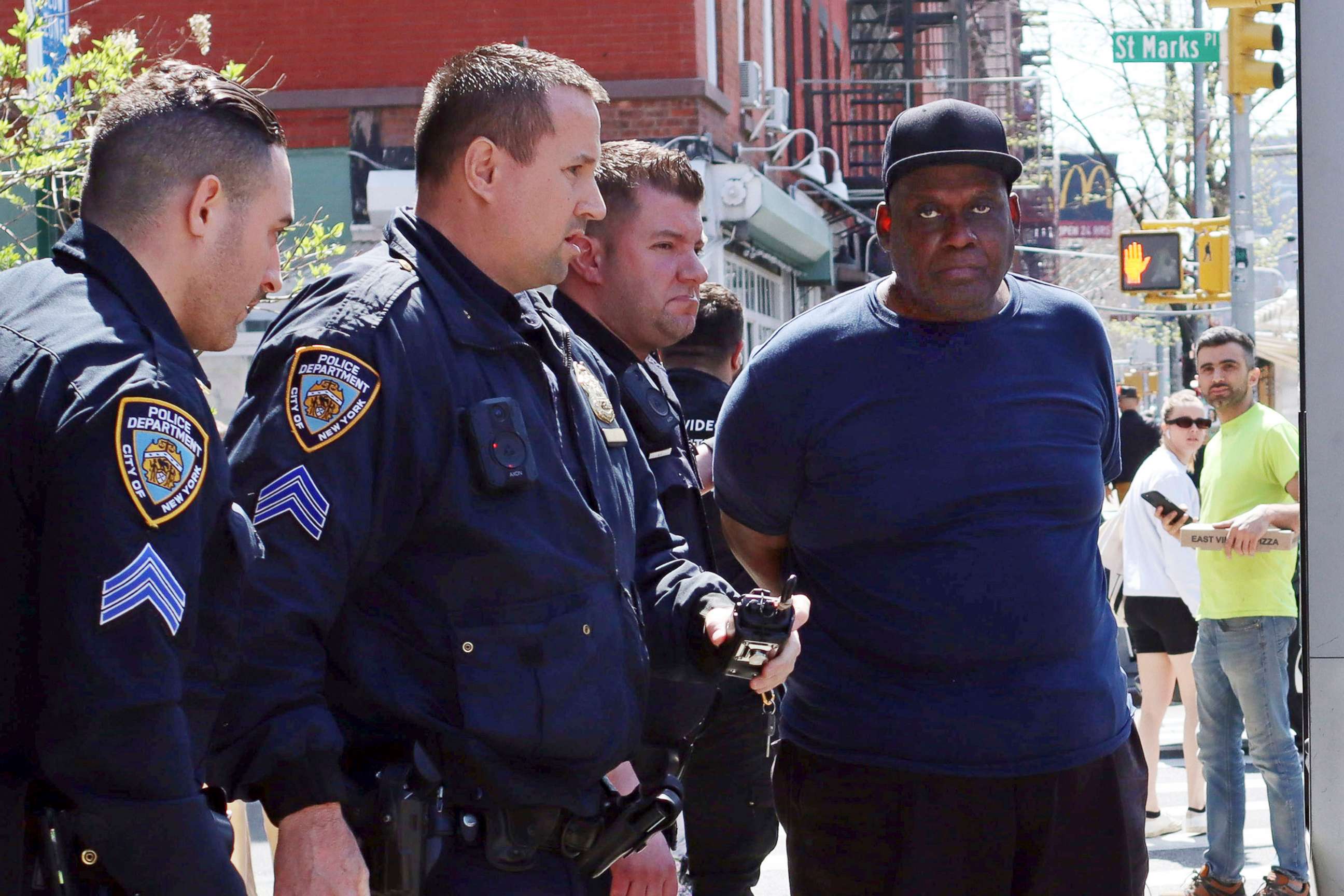 PHOTO: New York City Police Department officers arrest subway shooting suspect Frank R. James, 62, in New York, on April 13, 2022.
