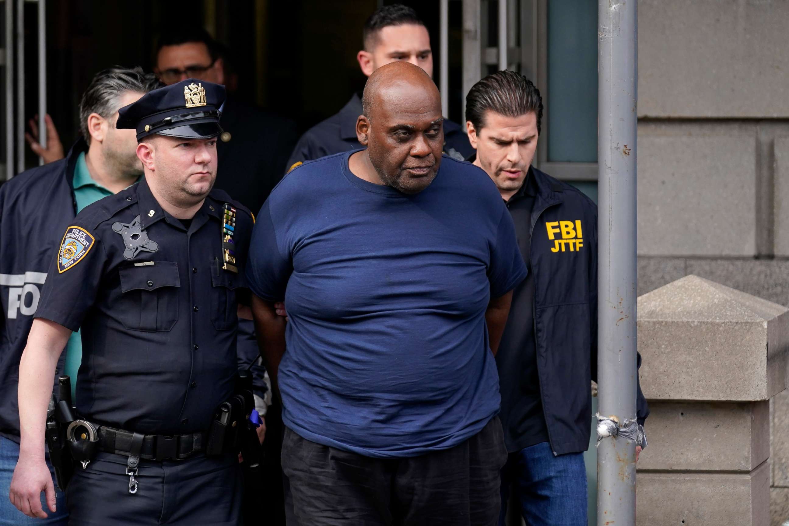 PHOTO: New York City Police and law enforcement officials lead subway shooting suspect Frank James, center, away from a police station, in New York, April 13, 2022.
