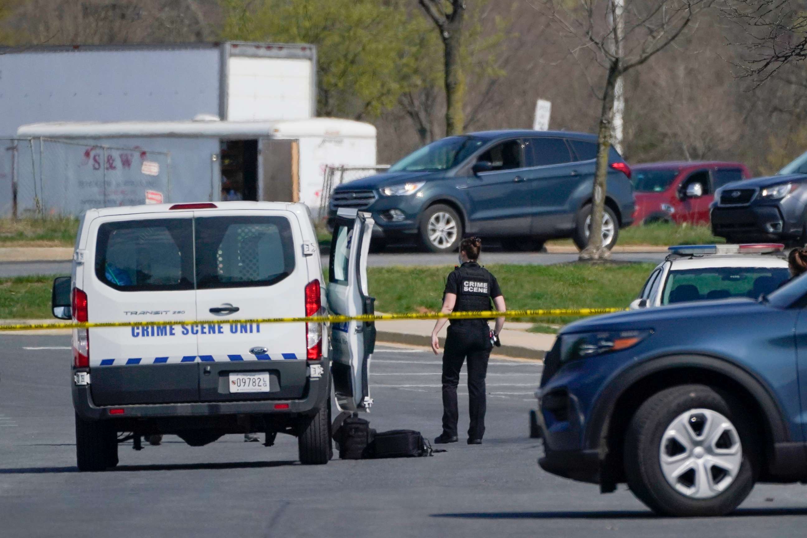 PHOTO: A crime scene technician stands near the scene of a shooting at a business park in Frederick, Md., April 6, 2021.