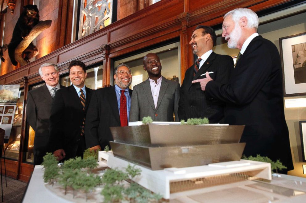 PHOTO: Designers of the winning concept for the National Museum of African American History and Culture meet with members of the Smithsonian Institution, in front of a model of the winning design, in Washington, D.C., April 14, 2009.