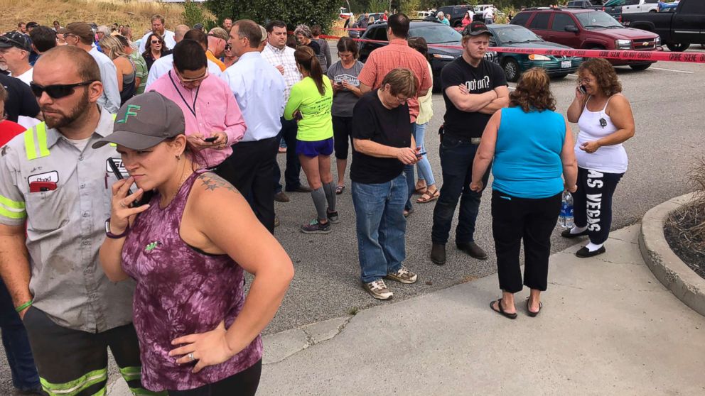 PHOTO: Parents gather in the parking lot behind Freeman High School in Rockford, Wash. to wait for their children, after a deadly shooting at the school on Sept. 13, 2017.
