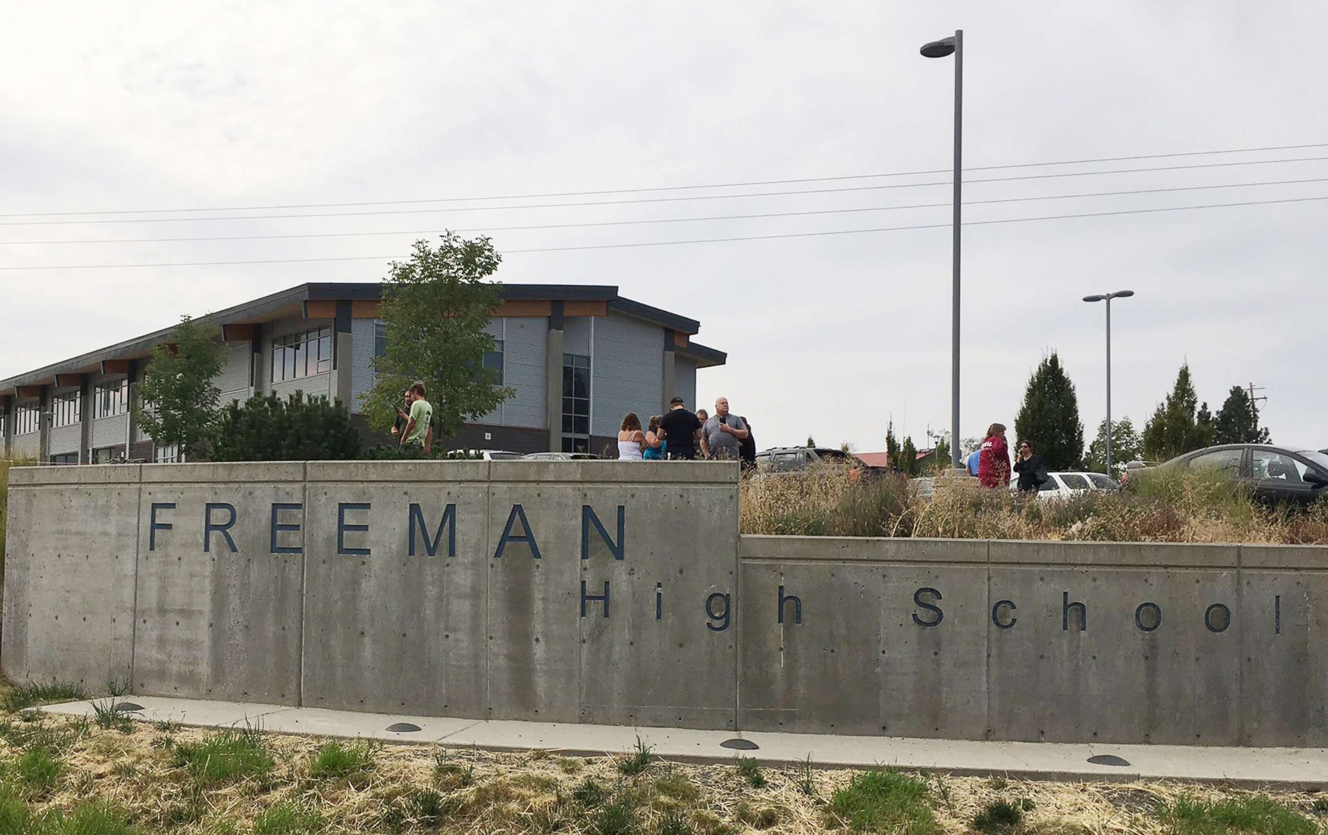 PHOTO: People gather outside Freeman High School after reports of a shooting at the school in Rockford, Wash., on Sept. 13, 2017.