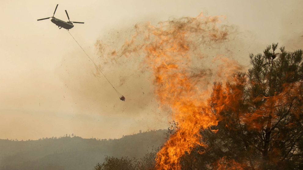 PHOTO: A firefighting helicopter drops water on the French Fire near State Route 155, Aug. 24, 2021, near Wofford Heights, California.