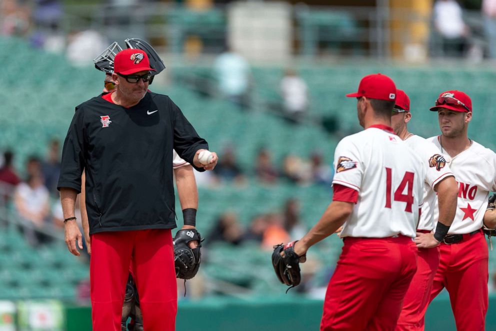 PHOTO: Fresno Grizzlies manager Randy Knorr hands the ball to relief pitcher Tanner Rainey (14) during a game against the Reno Aces at Chukchansi Park, April 8, 2019, in Fresno, California.
