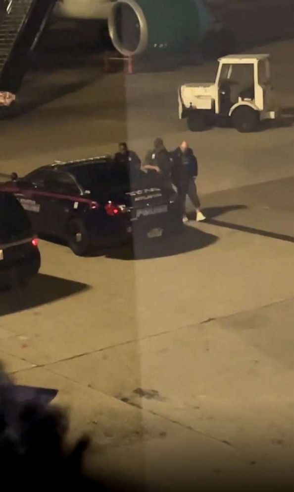 PHOTO: Bystander footage captures police escorting a passenger off a Frontier Airlines flight after it made an emergency landing at Hartsfield-Jackson Atlanta International Airport, Nov. 11, 2022.