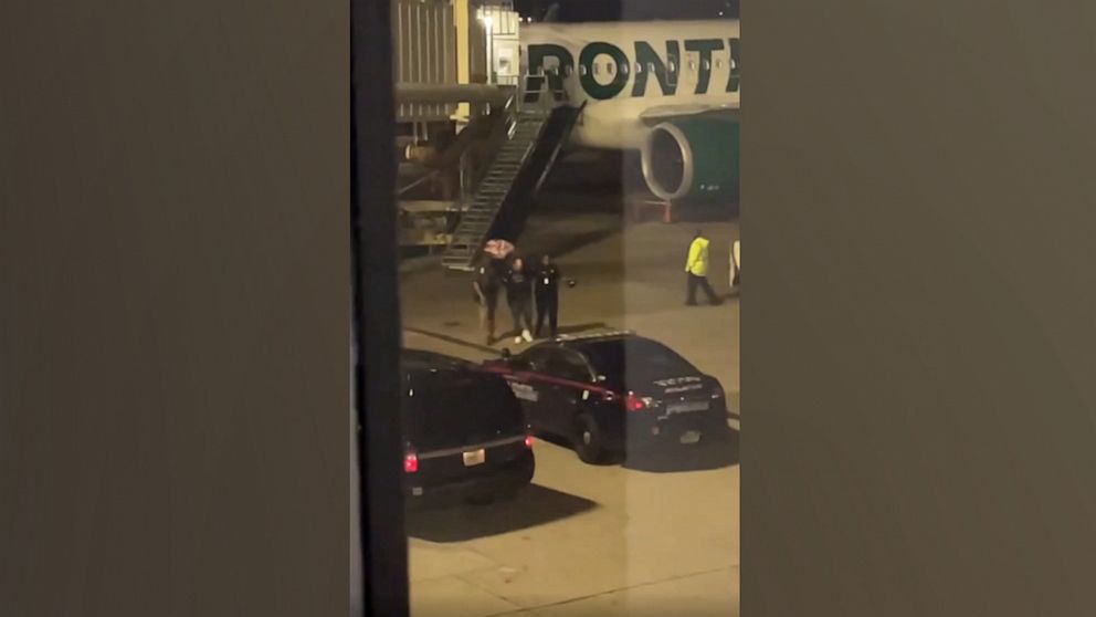 PHOTO: Bystander footage captures police escorting a passenger off a Frontier Airlines flight after it made an emergency landing at Hartsfield-Jackson Atlanta International Airport, Nov. 11, 2022.