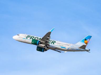 Airline passenger breaks window, restrained by other passengers