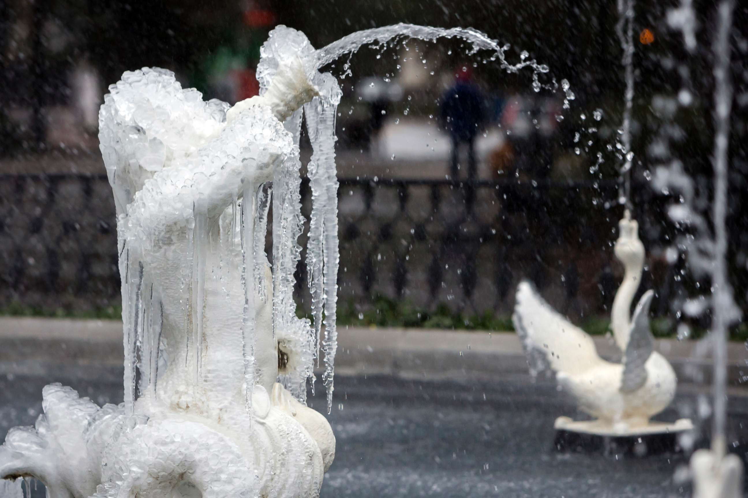 PHOTO: A frozen fountain in Historic Forsyth Park still works despite freezing temperatures and rain, Jan. 3, 2018, in Savannah, Ga. 
