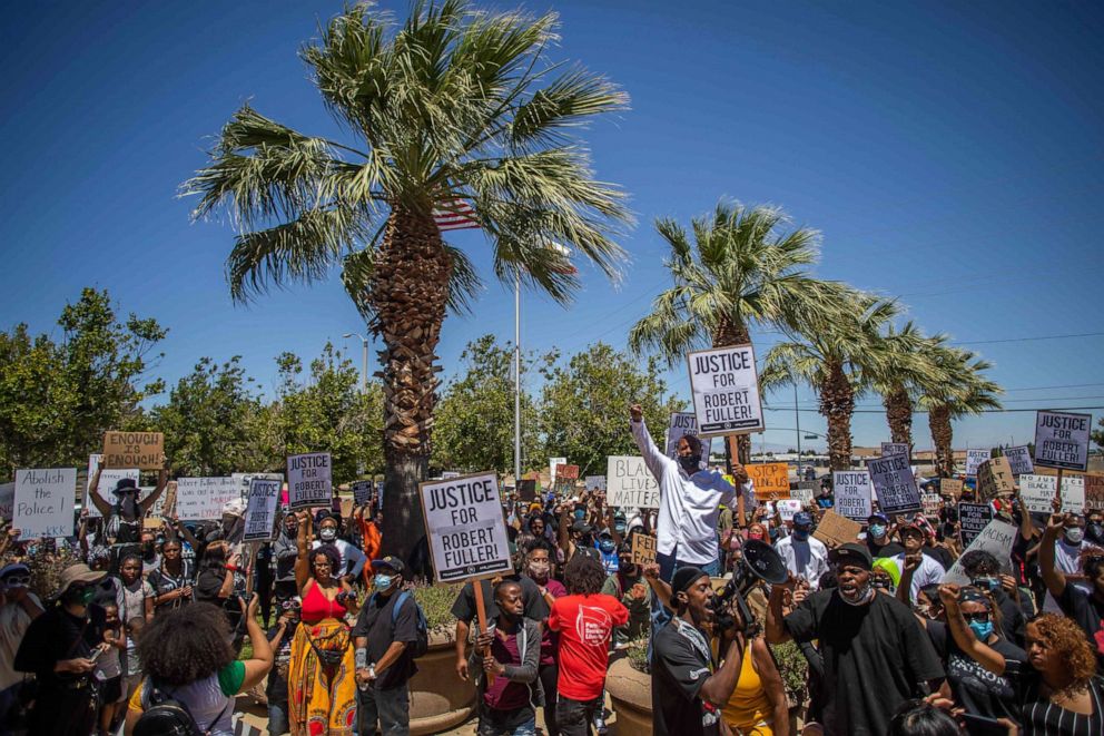 PHOTO: People hold placards and chant slogans as they protest in front of Palmdale Sheriffs Station on June 13, 2020 to demand a full investigation into the death of Robert Fuller.