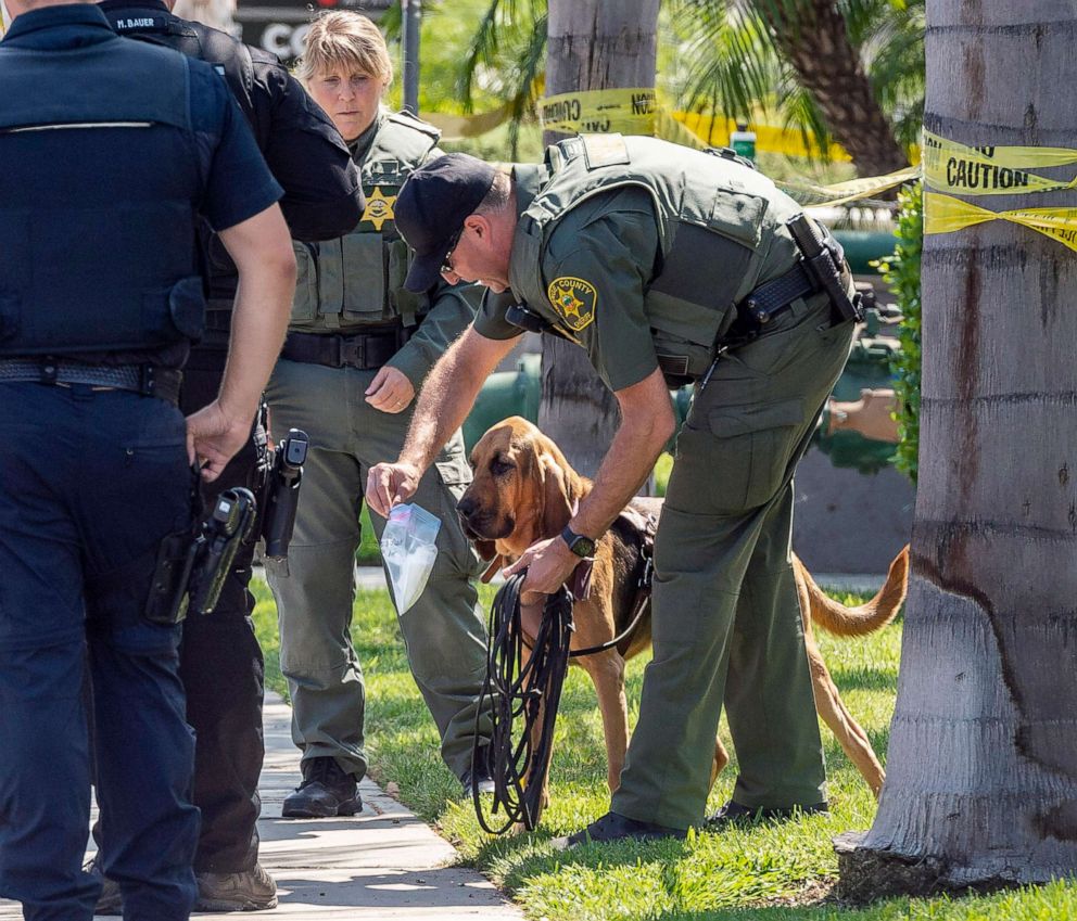 PHOTO: Police use a bloodhound while searching for a suspect that stabbed to death a retired Cal State Fullerton administrator, Aug. 19, 2019 in Fullerton, Calif.