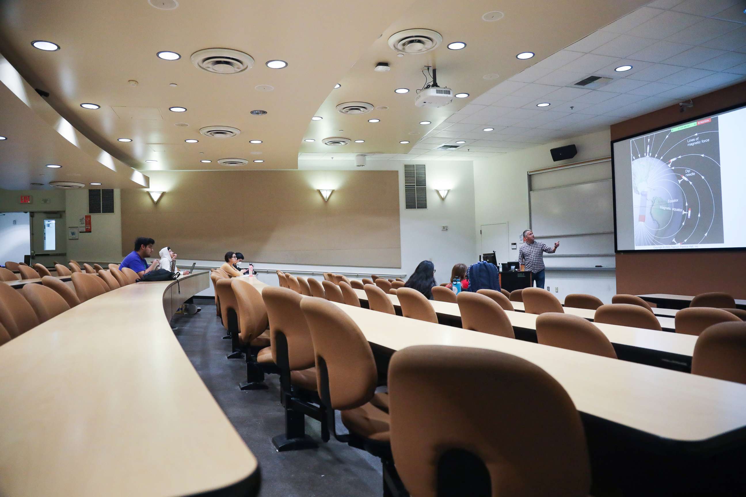 PHOTO: Professor Matthew Kirby gives a geological sciences lecture in March at Cal State Fullerton in Orange County, California. Most of the 120 students attended the class remotely, with only seven in person.