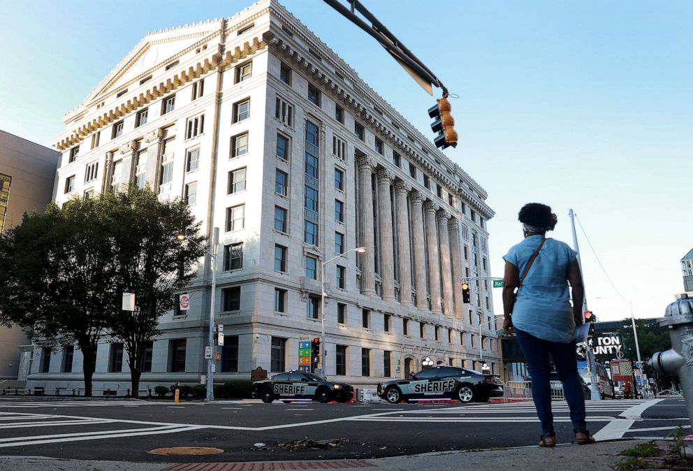 PHOTO: People walk near the Fulton County Courthouse as more security has been put in place on August 08, 2023 in Atlanta, Georgia.