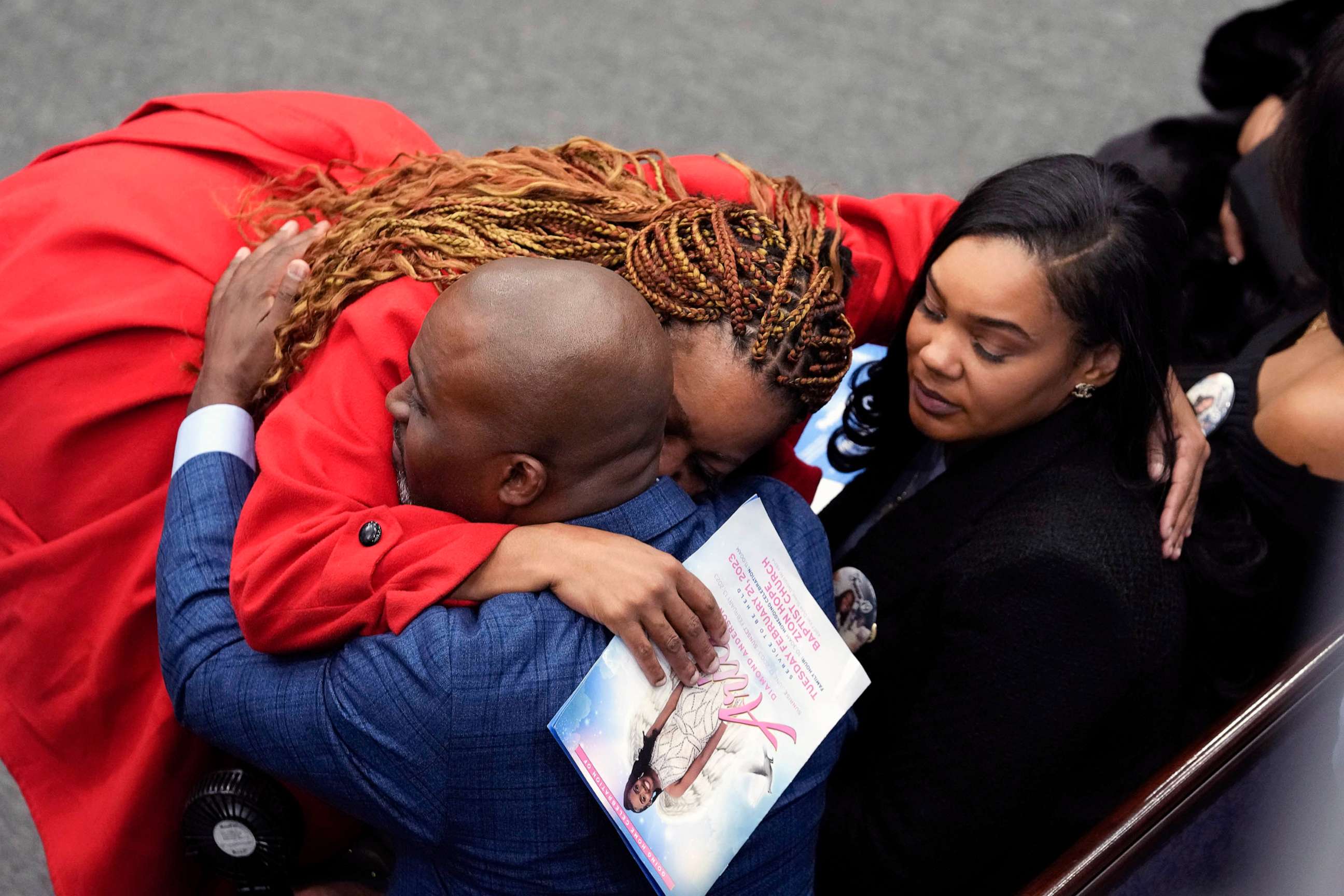 PHOTO: A mourner hugs Jerome Lloyd-Anderson and Dawana Davis, father and mother of Michigan State University shooting victim Arielle Anderson at a funeral in Detroit, Feb. 21, 2023.