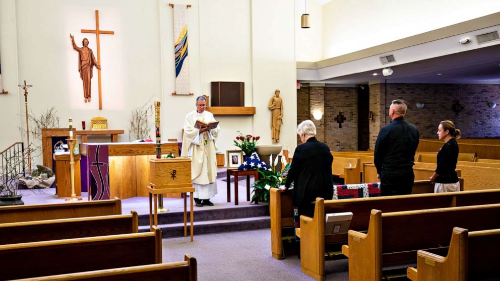 PHOTO: Father Sandy McDonald presides over the funeral of Ralph Ray, 73, at St. John Neumann Catholic Church in Columbia, SC., March 27, 2020.