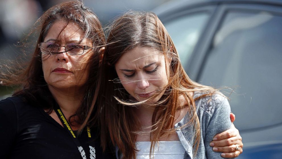 Mourners hug as they leave the funeral of Alaina Petty, in Coral Springs, Fla., Feb. 19, 2018. 