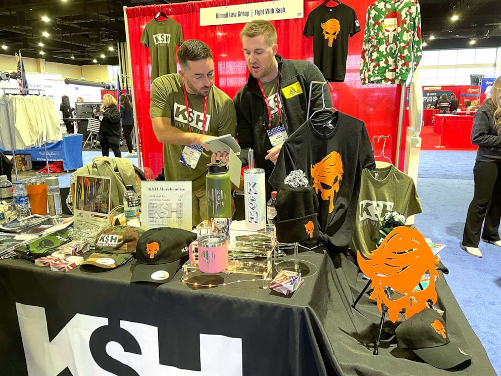 PHOTO: Two "Fight With Kash" associates stand at the charity's merchandise booth at the Conservative Political Action Conference on March 3, 2023. The charity shared the booth with its event co-sponsor, the Binnall Law Group.