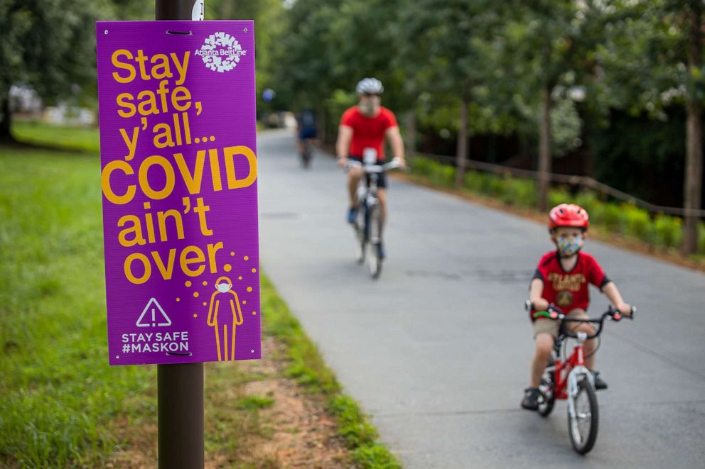 PHOTO:COVID-19 safety information signs are seen along the Atlanta Beltline pedestrian and bike trail in Atlanta, July 1, 2020.