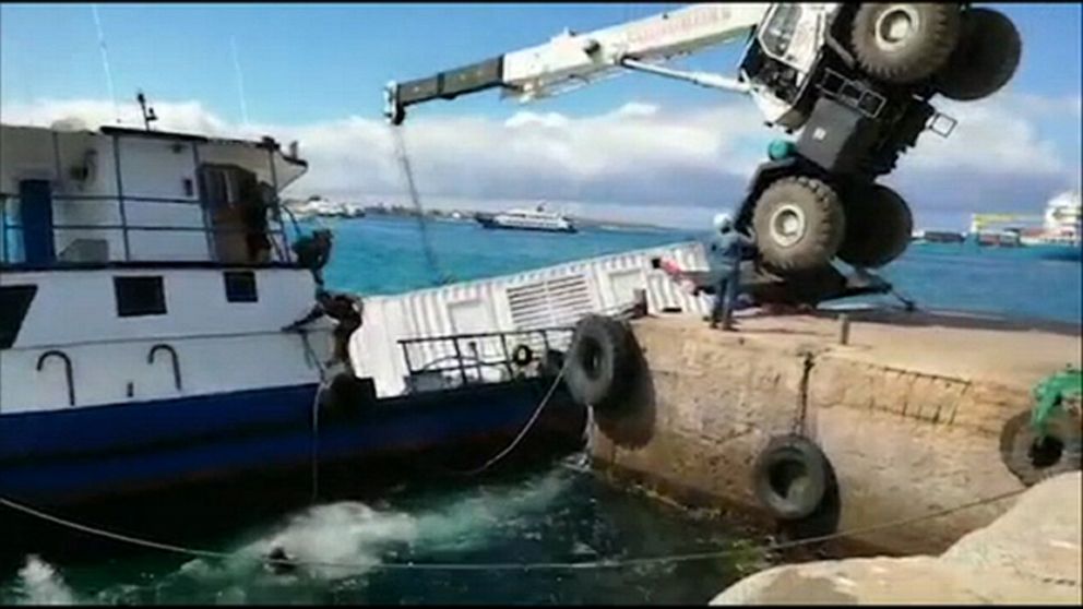 PHOTO: A crane falls on a barge carrying 600 gallons of diesel in a port on San Cristobal Island, in the Galapagos Islands, Ecuador, Dec. 22, 2019.
