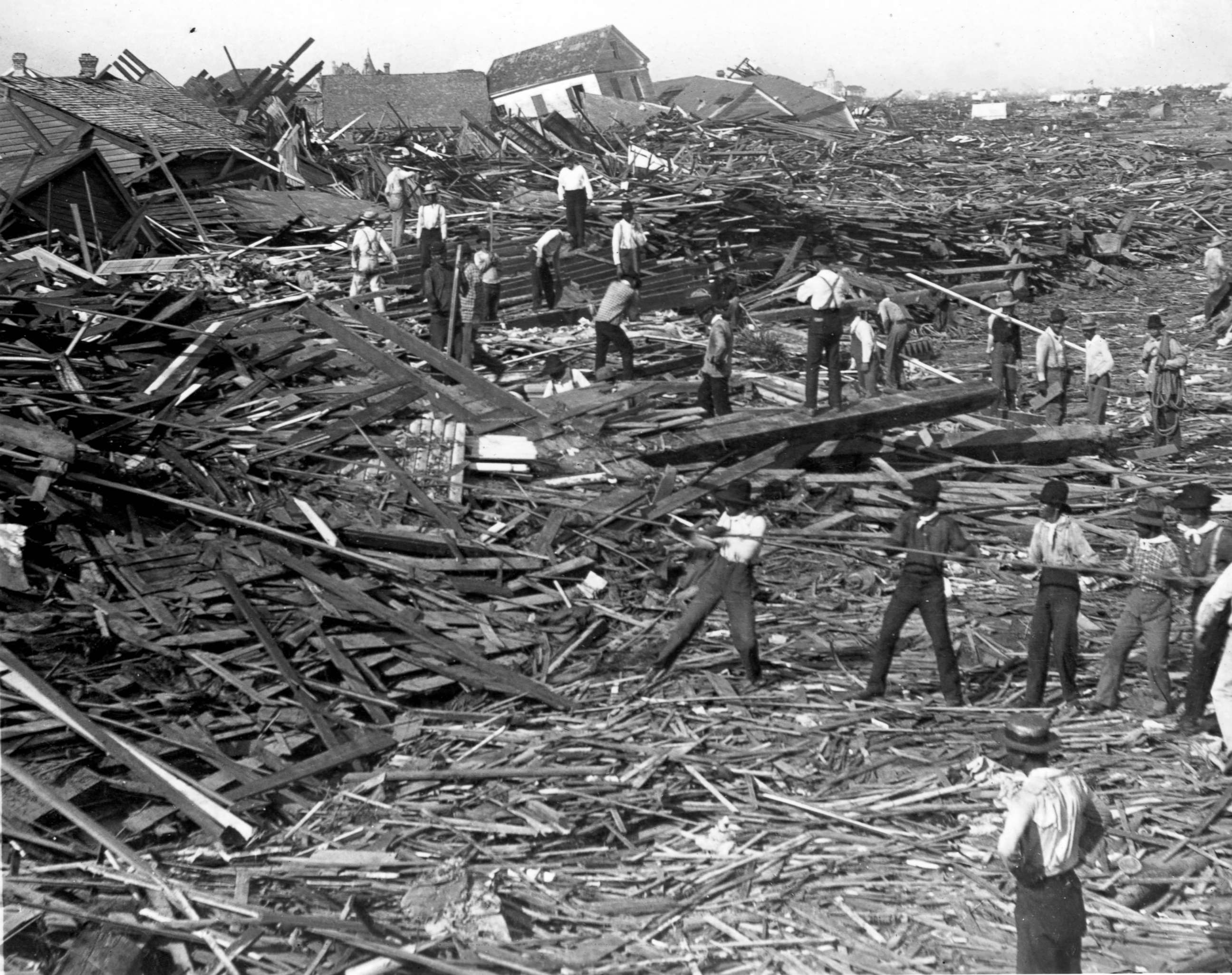 PHOTO: Men use ropes to pull away the debris of houses in order to look for bodies, after the Galveston Hurricane of 1900.