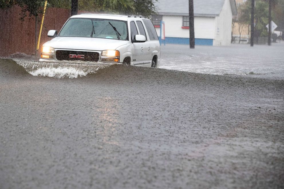 PHOTO: In this Sept. 22, 2020, file photo, a vehicle drives through floodwaters from Tropical Storm Beta, in Galveston, Texas.