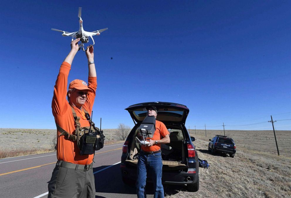 PHOTO: Keith Lonnquist and Reggie Franklin (left to right), with El Paso County Search & Rescue, launch a drone to search an area near Drennan Rd for missing, endangered child, Gannon Stauch on Sunday, Feb. 2, 2020.(Jerilee Bennett/The Gazette via AP)