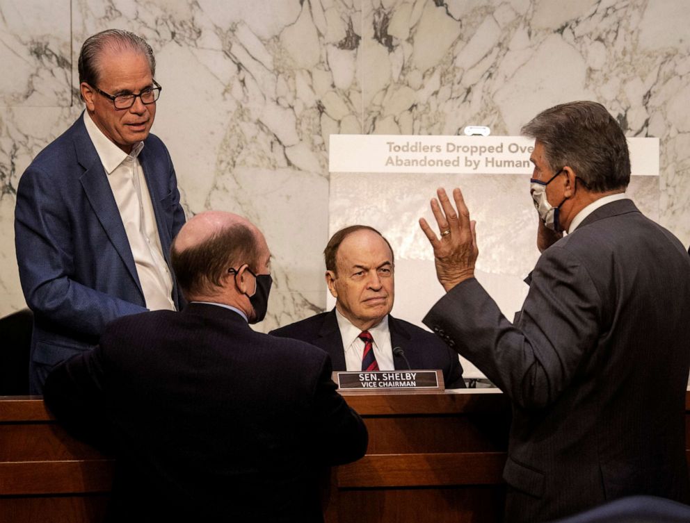 PHOTO: Republican senators Mike Braun, Chris Coons, Richard Selby and Joe Manchin talk during a break in the Senate Appropriations committee hearing to examine domestic violent extremism, on May 12, 2021, in Washington, D.C.