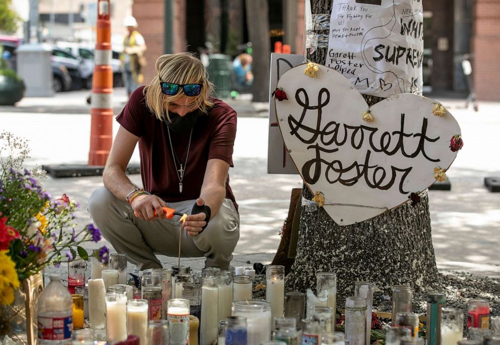 PHOTO: A visitor lights incense at a memorial to Garrett Foster on July 31, 2020, in Austin, Texas, after U.S. Army Sgt. Daniel Perry was identified as the man who fatally shot Foster at a Black Lives Matter protest on July 25.