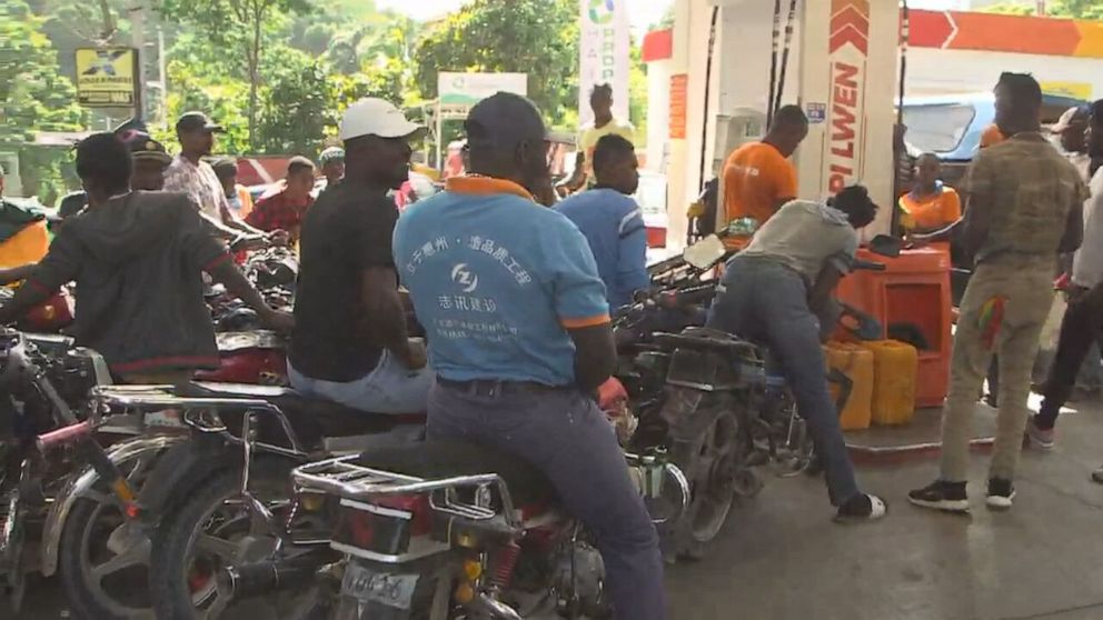 PHOTO: With shortages of food and fuel commonplace in Haiti, people gather to fill up.