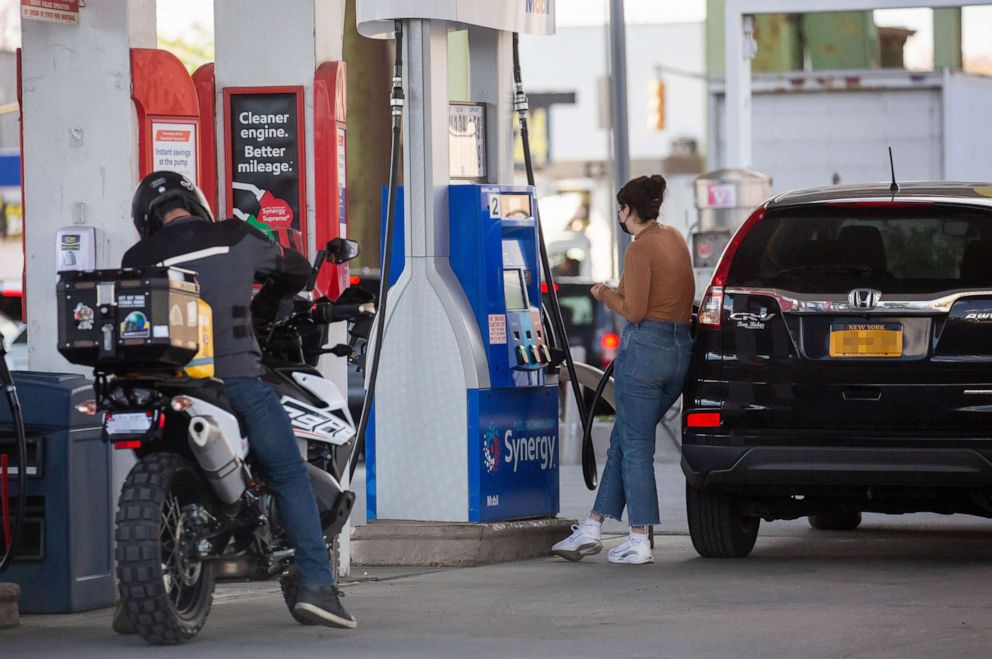 PHOTO: People pump gas at an ExxonMobil gas station in Brooklyn, N.Y., May 13, 2021.