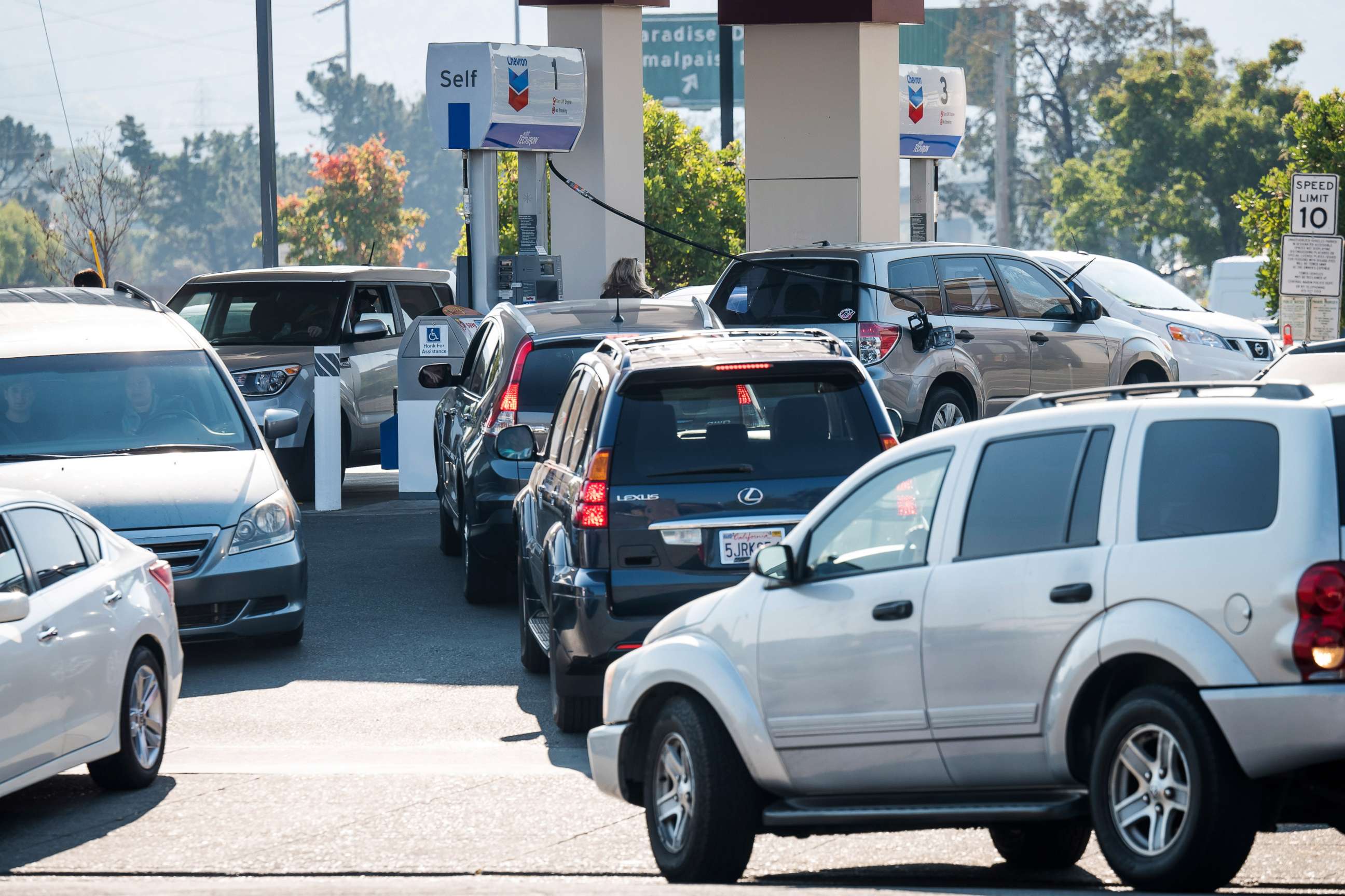 PHOTO: Customers wait in line to get gas at a gas station in Corte Madera, Calif., Oct. 29, 2019.