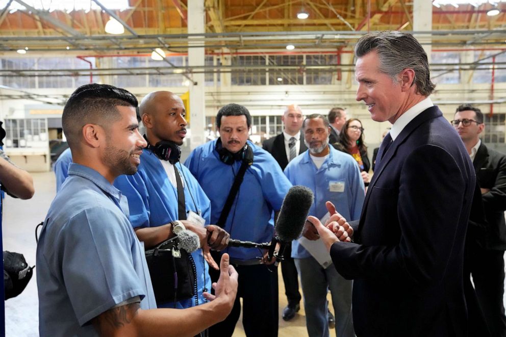PHOTO: Incarcerated men visit with California Gov. Gavin Newsom after he spoke inside an empty warehouse at San Quentin State Prison in San Quentin, Calif., Mar. 17, 2023.