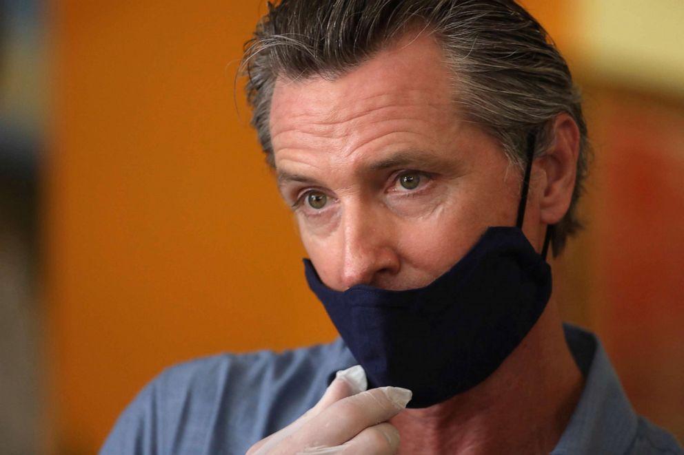 PHOTO: In this June 3, 2020, file photo California Gov. Gavin Newsom is interviewed while visiting the Hot and Cool Cafe in Leimert Park in Los Angeles. 