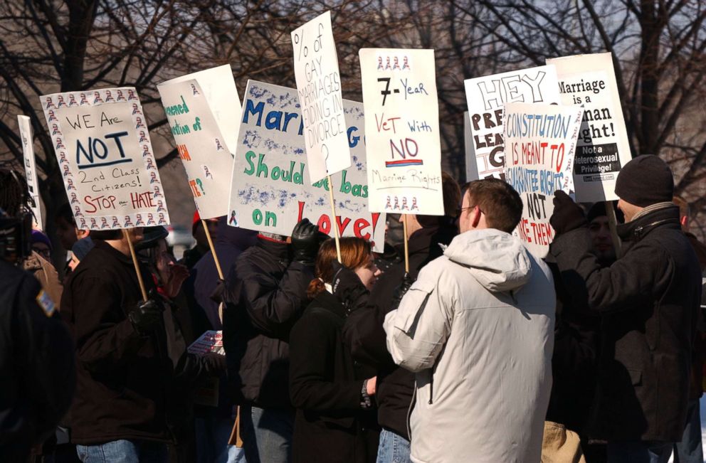 PHOTO: Activists rally for equal rights and against a proposed amendment to the Constitution banning equal marriage rights for same sex couples in front of the residence of Cardinal Francis George Feb. 14, 2004 in Chicago.